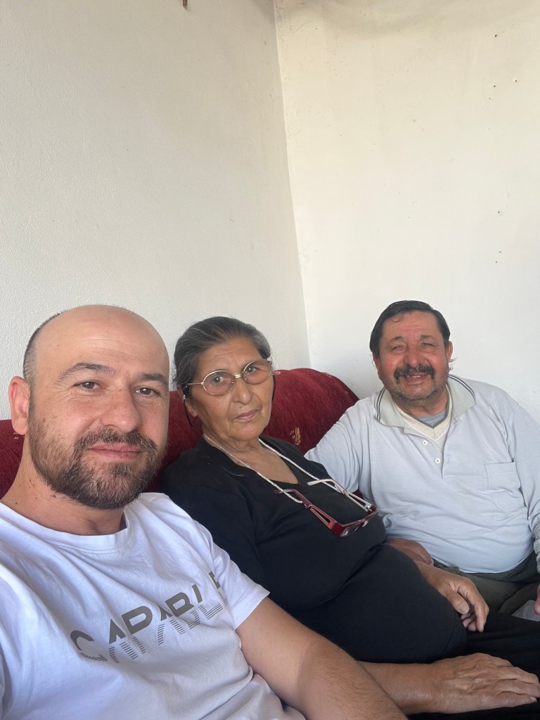 A yellow plate containing a light brown oval-shaped food item, likely a hard-boiled egg, placed on a flat orange surface. ...